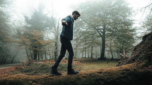 Rear view of man standing in forest