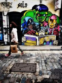 Full length of man walking on multi colored city street