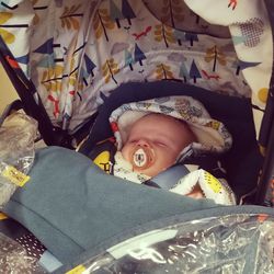 High angle portrait of cute baby lying on bed