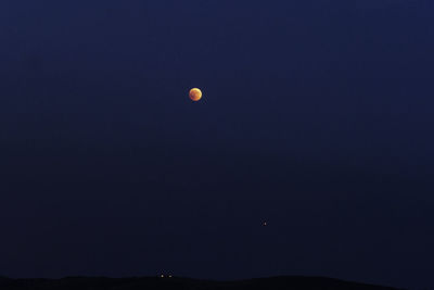 Low angle view of moon against sky at night