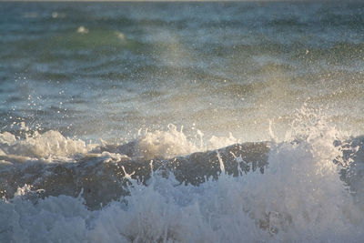 High angle view of waves splashing on sea