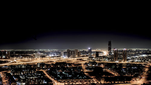 High angle view of illuminated buildings against sky at night