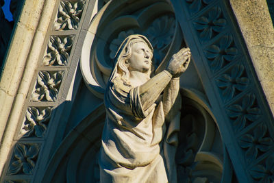 Low angle view of statue against temple