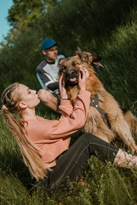 Active family, fitness couple, pet love, dog training, best dog breeds for family. young sports 