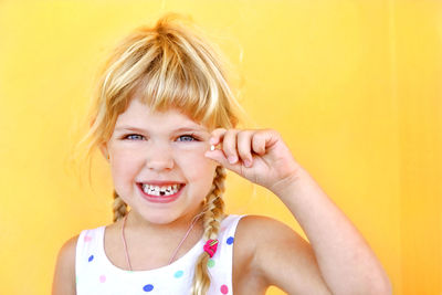 Portrait of smiling young girl with first tooth