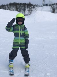 A little boy is skiing. snowboarding. ski resort.