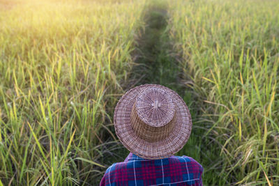 Rear view of person wearing hat on field