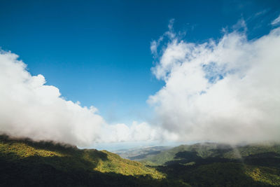 Scenic view of green mountains against sky