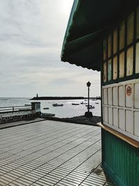 Scenic view of sea by building against sky