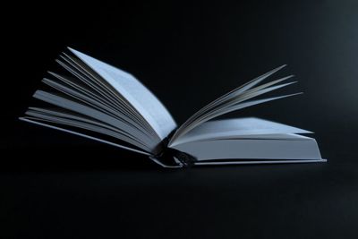 Close-up of open book over black background