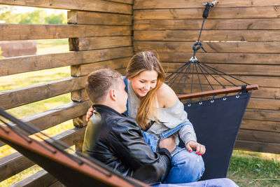 Young couple sitting outdoors