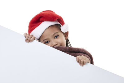 Portrait of cute girl wearing hat against white background