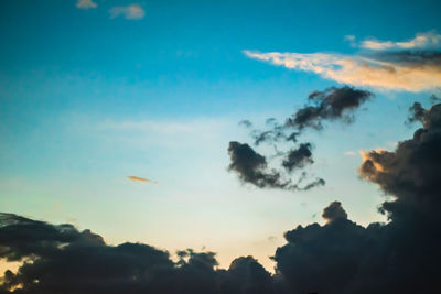 Low angle view of silhouette trees against sky during sunset