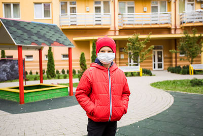 Full length portrait of man standing on footpath