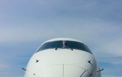 Low angle view of airplane flying against sky