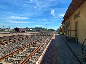 Railroad tracks amidst buildings against sky