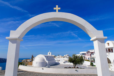 Built structure by building against blue sky