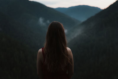 Rear view of woman against forest