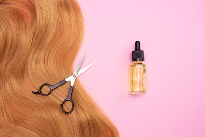 Close-up of electric lamp against pink background