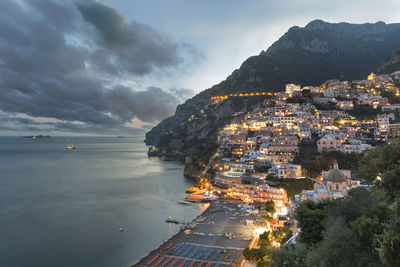 High angle view of sea and cityscape against sky