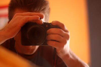 Close-up of woman holding camera