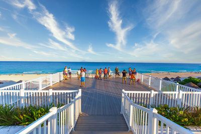 People on beach against sky