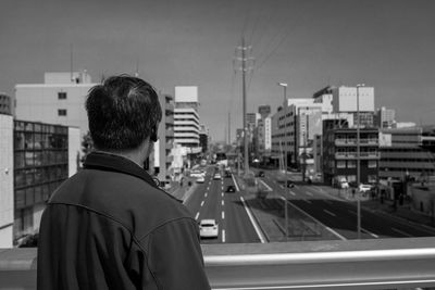 Rear view of man standing in city