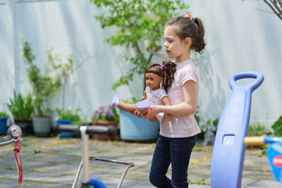 Cute young girl playing in the backyard on a sunny day