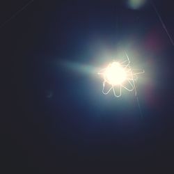 Low angle view of illuminated lights at night