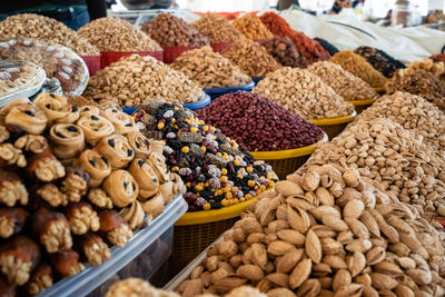 View of colorful sweets and nuts on showcase of local food market, uzbekistan	
