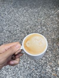 Cropped image of hand holding coffee cup