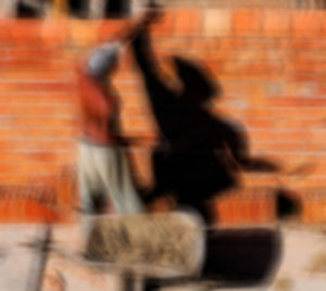 Blurred motion of man standing against orange wall