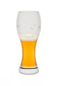 Close-up of beer glass against white background