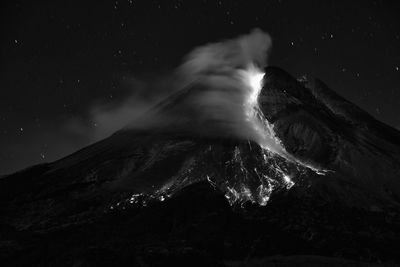 Scenic view of mountains against sky at night