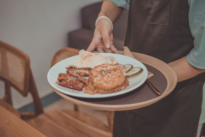 Midsection of man having food on table