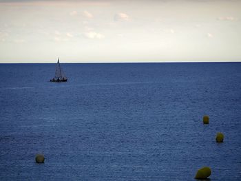 Sailboat in sea against sky