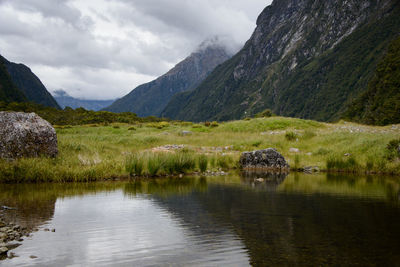 Scenic view of lake and mountains against sky