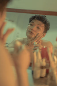 Portrait of shirtless boy looking at camera