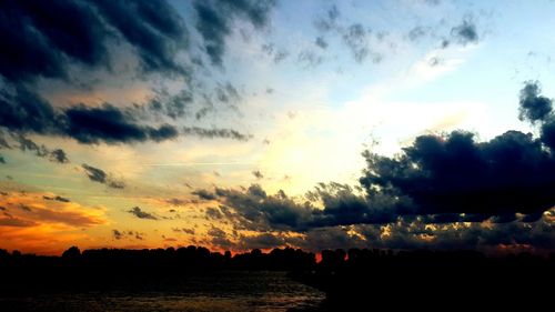 Scenic view of dramatic sky over sea during sunset