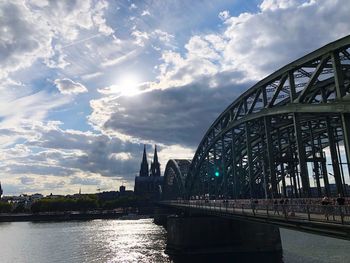 View of bridge over river against cloudy sky