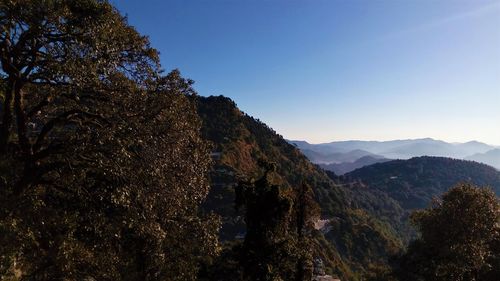 Scenic view of tree mountains against clear sky