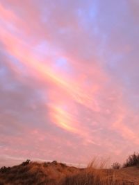 Scenic view of field against sky at sunset