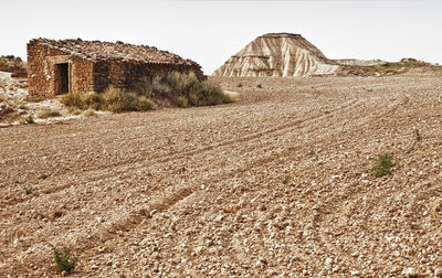 Old ruins on field against clear sky