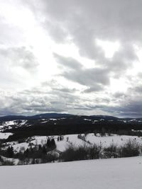 Scenic view of landscape against sky during winter