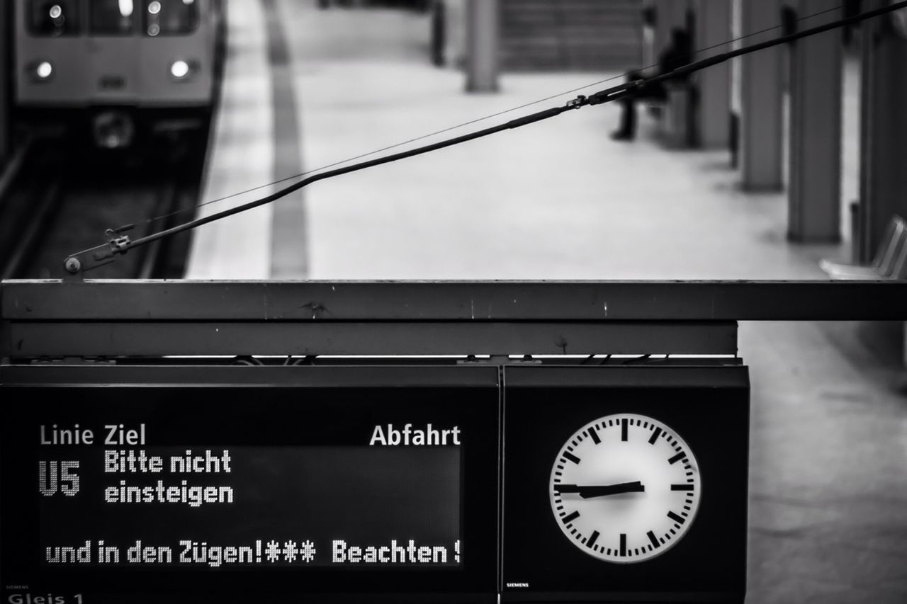 clock, text, number, communication, time, low angle view, western script, indoors, technology, old-fashioned, hanging, close-up, information sign, focus on foreground, illuminated, no people, retro styled, clock face, accuracy, non-western script