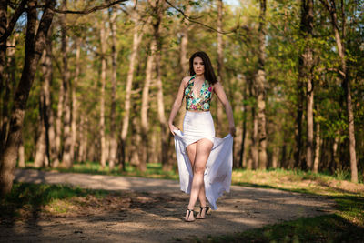 Full length portrait of woman in forest