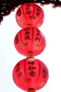 Low angle view of lanterns hanging on street light