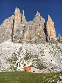 Three peaks of lavaredo and the homonym refuge in a summer beautiful day.
