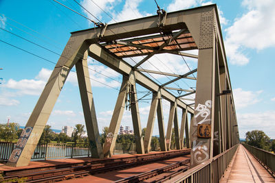 Railway bridge against cloudy sky