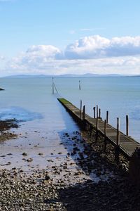 Jetty in sea against sky